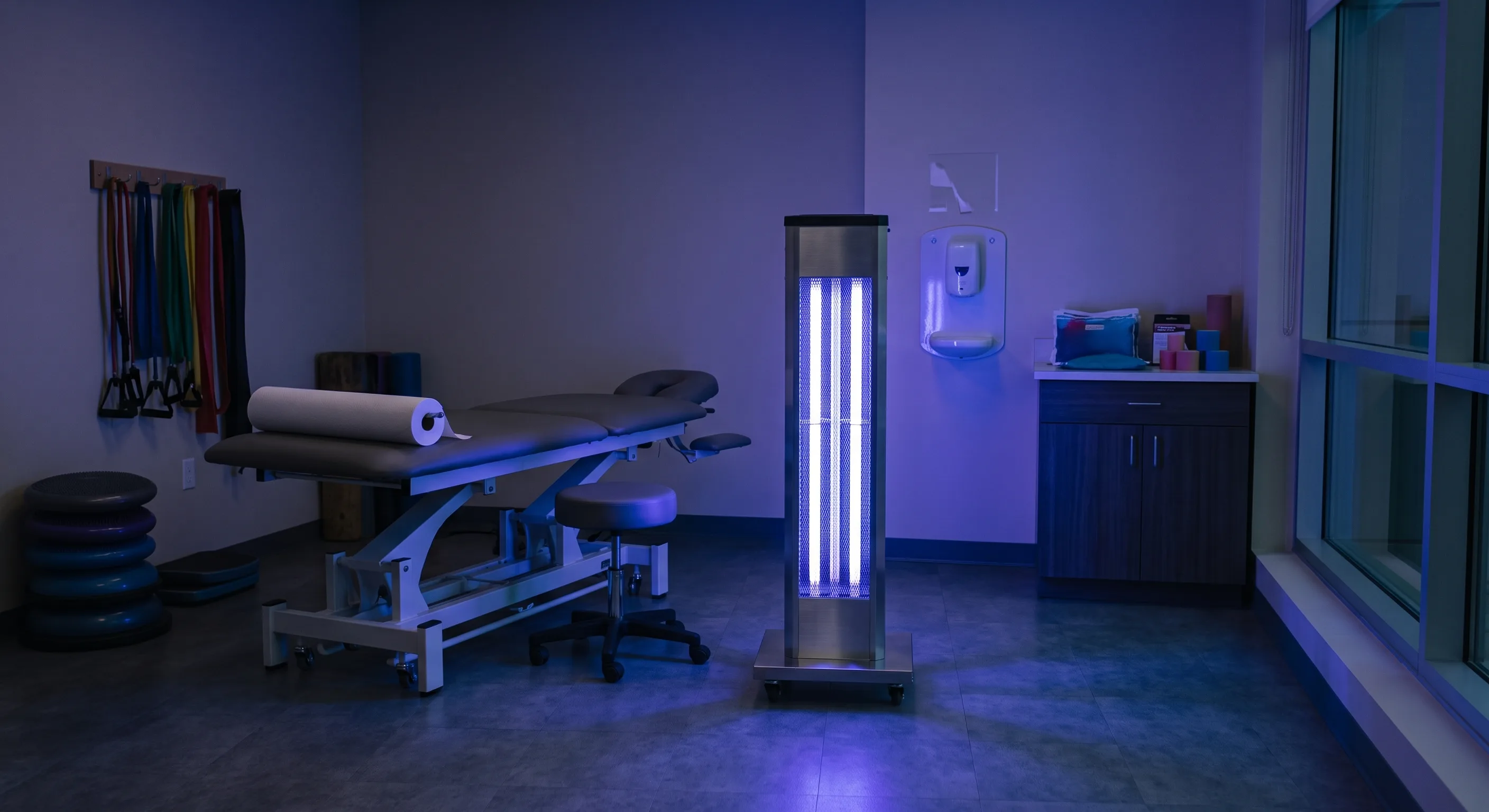 UV-C sanitizing tower disinfecting a treatment room